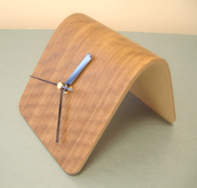 A small desk clock formed in a Bagpress